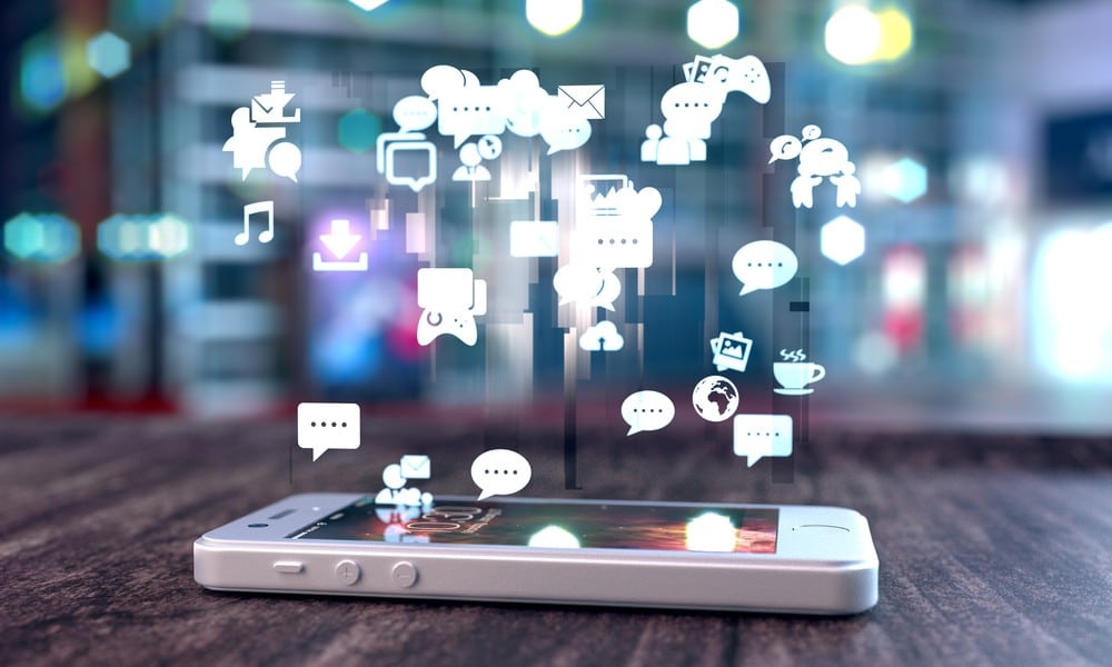 Image of cell phone with mini graphics of messages and videogames coming out of phone