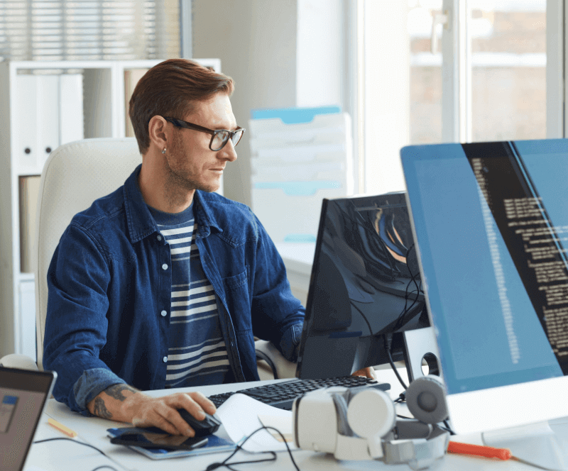 Image of man looking at computers