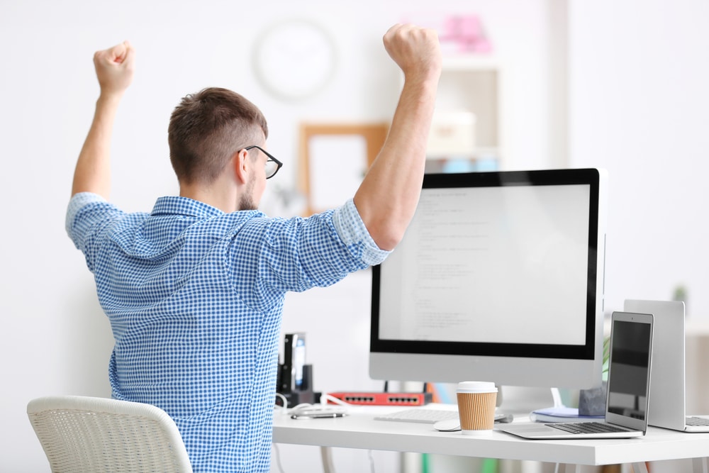 Man celebrating ease of kobitons mobile app testing