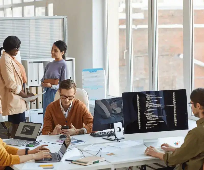 Image of employees in office continuously testing across OS versions