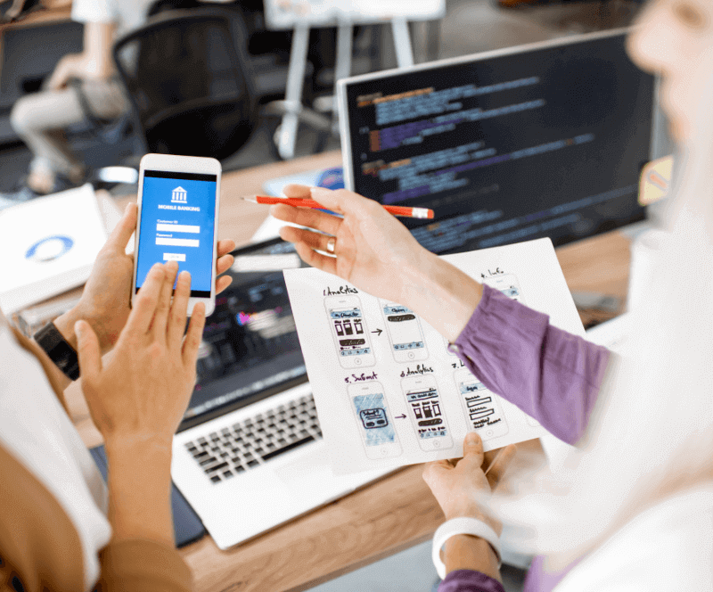 People designing an app on a phone